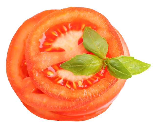 Slices of fresh tomato with basil isolated on white