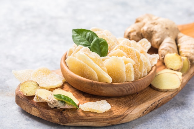 Slices of ginger dried fruit  and ginger root on a stone table