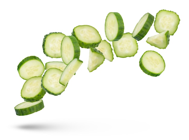 Slices of green cucumbers on a white isolated background Slices of green cucumbers scatter in different directions The concept of a delicious addition to a salad High quality photo