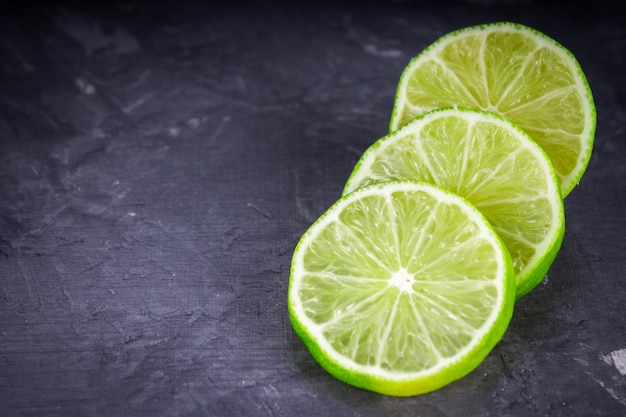 Slices of lime on a gray marble background