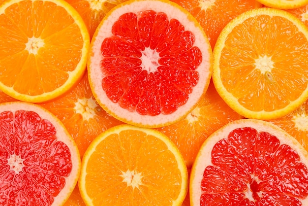 Slices of oranges and a grapefruits as a background