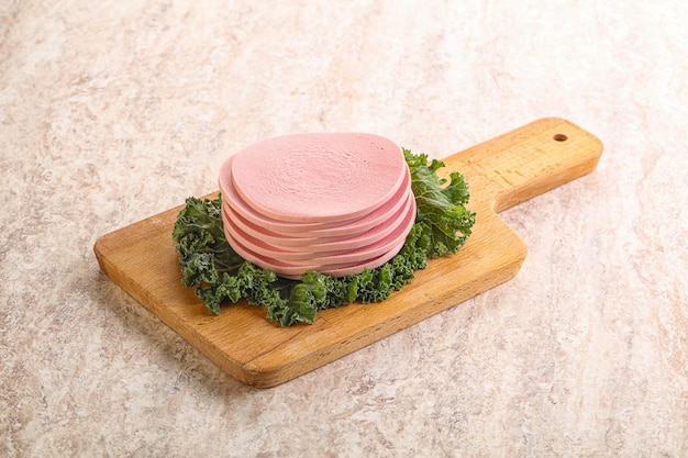 Slices pork sausage over board