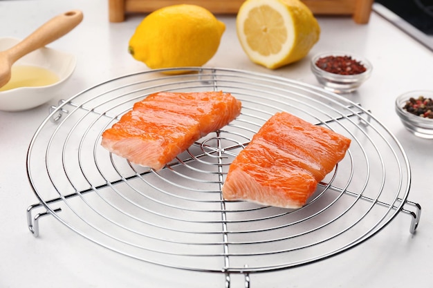 Slices of red fish fillet on white table