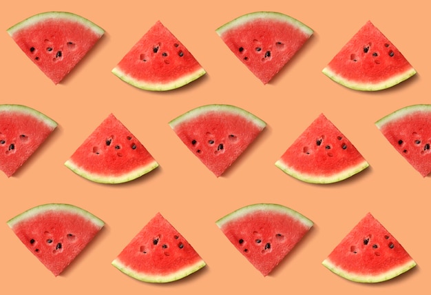 Slices of ripe, red watermelon on a beige background