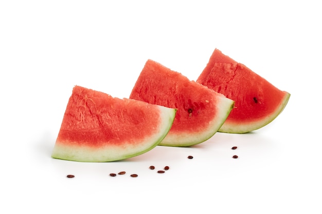 Slices of ripe, red watermelon, isolated on a spruce background