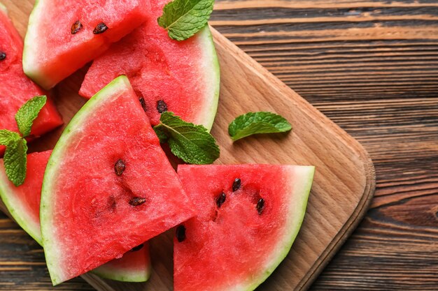 Slices of ripe watermelon on wooden board