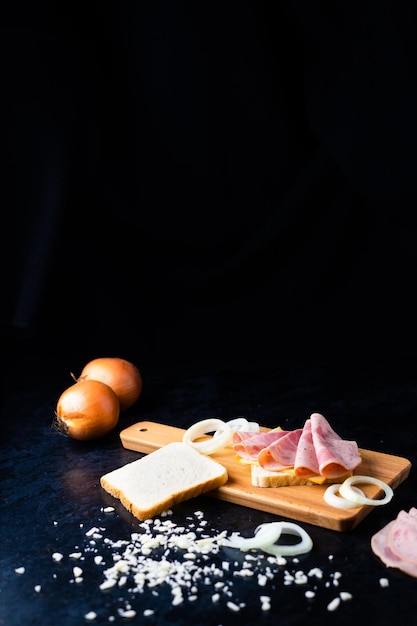 Slices of sausage Mortadella and onion on a cutting board