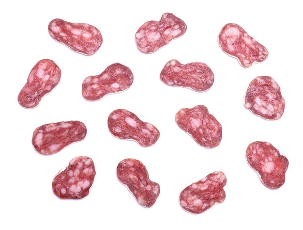 Slices of spanish fuet thin dried salami sausage isolated on a white background