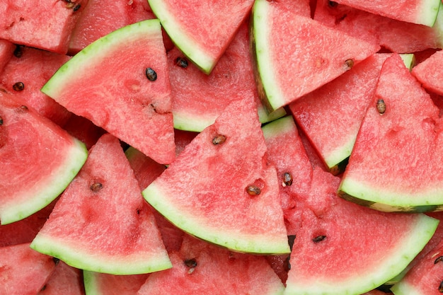 Slices of tasty ripe watermelon as background top view