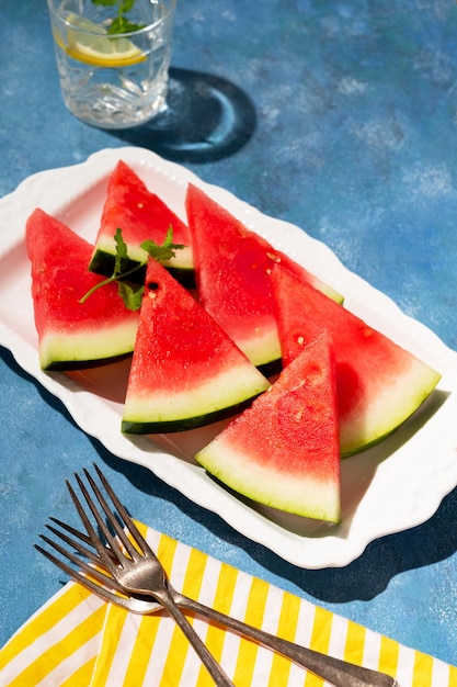 Slices of watermelon in a plate blue background Healthy food