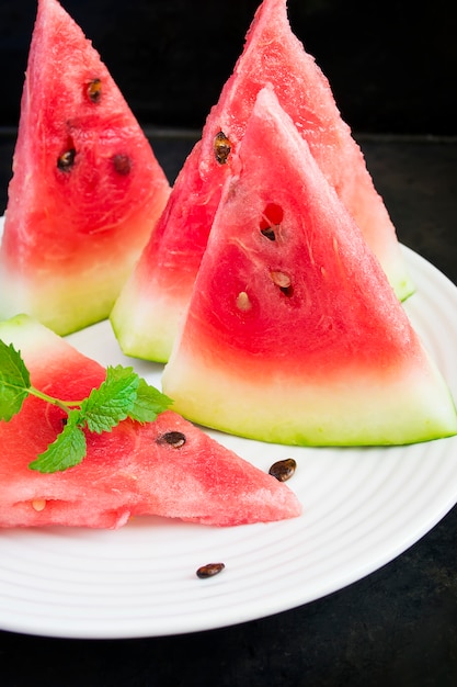 Slices of watermelon on a white plate.