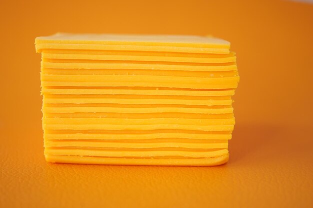 Slicing cheese into pieces closeup