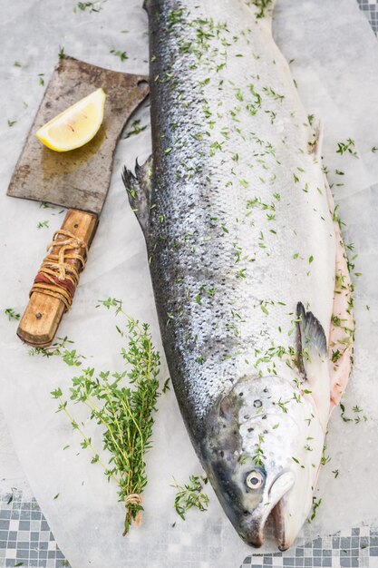 Slicing whole salmon on an old white table