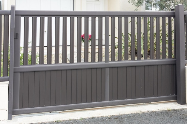 Sliding gray gate steel big grey metal portal fence on modern house street