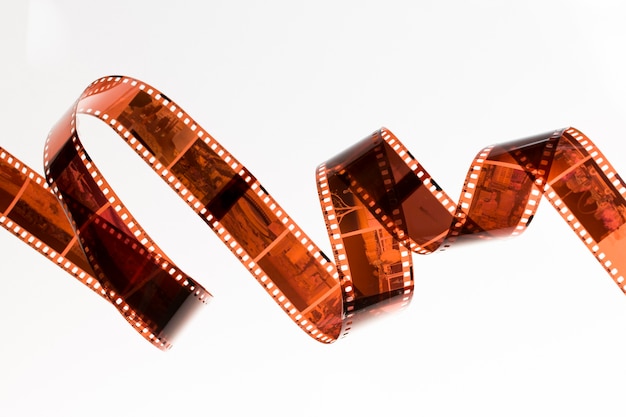 Slightly rolled undeveloped film strip isolated on white background