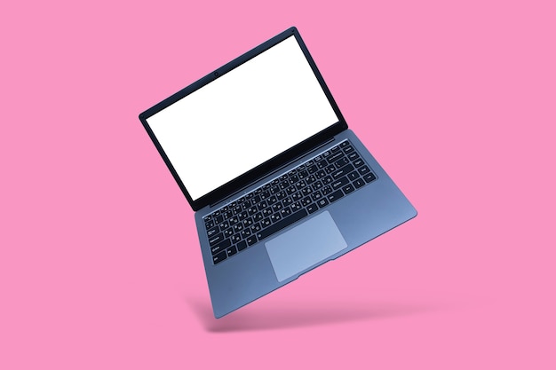 Slim modern laptop with white screen mockup on pink background with shadow.