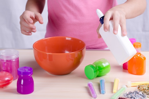 Slime making process. Girl making slime, worldwide popular self made toy.