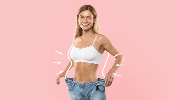 Slimming Result Happy Slim Woman Wearing Oversized Jeans Posing On Pink Background