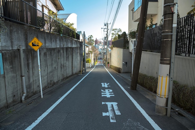 Slope of the town in Tokyo Japan Translation on the ground text STOP