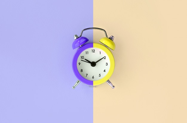 A small alarm clock is located between the violet and cream areas