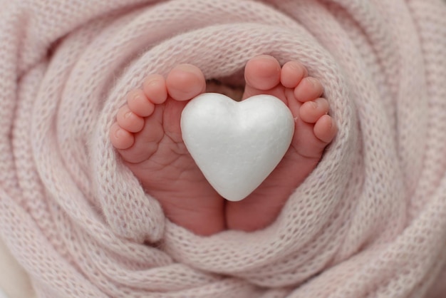 Small beautiful legs of a newborn baby in the first days of life Baby feet of a newborn