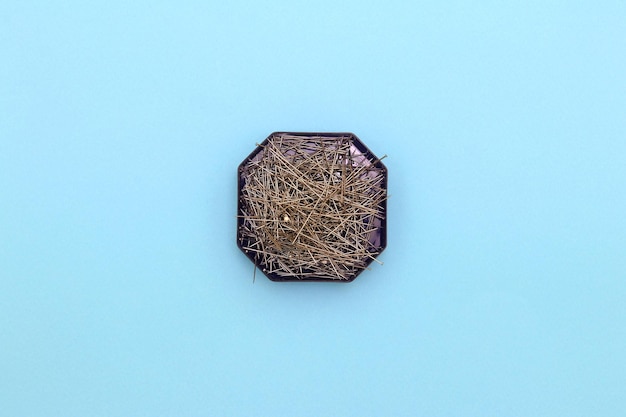 A small black and purple hexagon shaped object sits on a blue background.