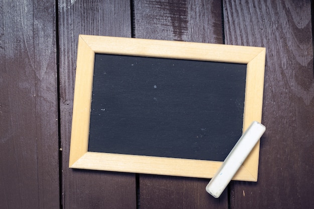 Small blackboard on old wood 