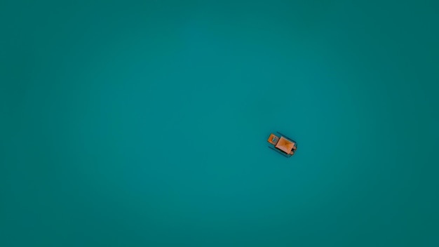 Small boat or raft tourist floating on green water color background minimal photograph for poscard and bacground abstrac concept aerial top view