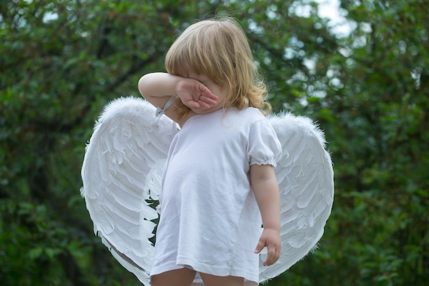 Small boy in angel wings