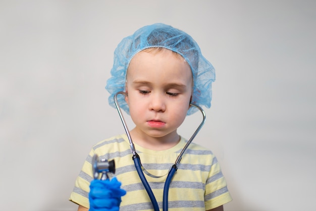 Small boy playing doctor with stethoscope