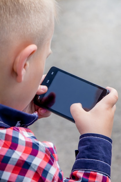 Small boy with  smartphone in his hands