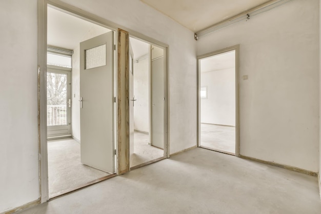 A small bright corridor with an entrance to several rooms in a small residential building