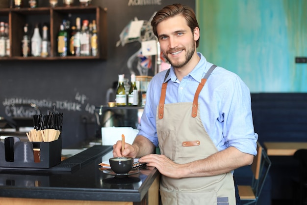 Small business owner working at his cafe.