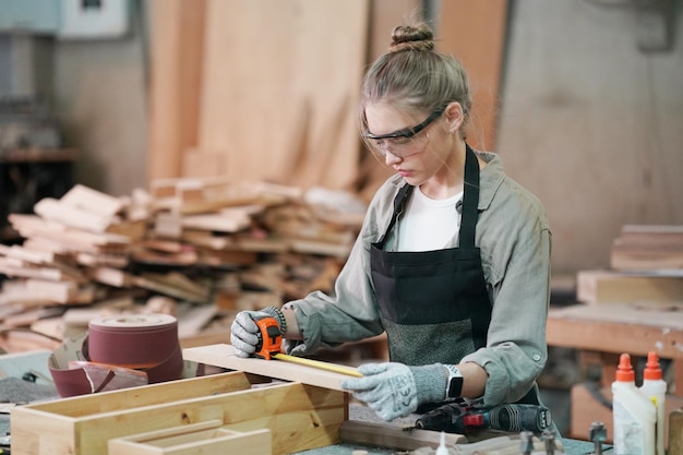 Small business of a young woman Attractive young woman carpenter designer works in workshop