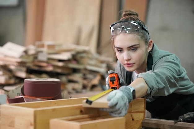 Small business of a young woman Attractive young woman carpenter designer works in workshop