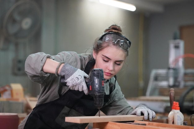 Small business of a young woman in furniture workshop background