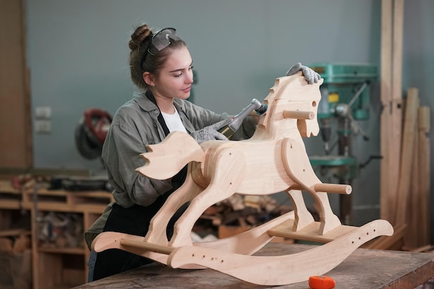 Small business of a young woman in furniture workshop background