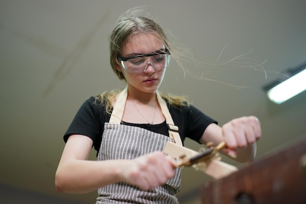 Photo small business of a young woman in furniture workshop background