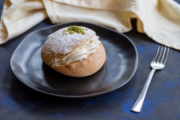 Small cake on the table traditional french flavor with cream in the middle alman pastasi