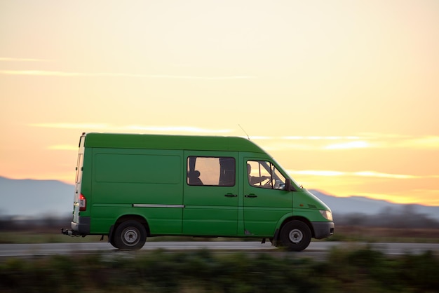 Small cargo van driving on highway hauling goods. Delivery transportation and logistics concept. Kyiv, Ukraine - July 17, 2021.