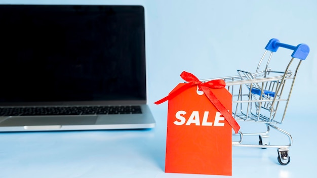 A small cart for a supermarket on a computer background