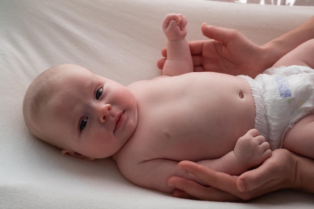 Small caucasian boy lying at bed looking at camera