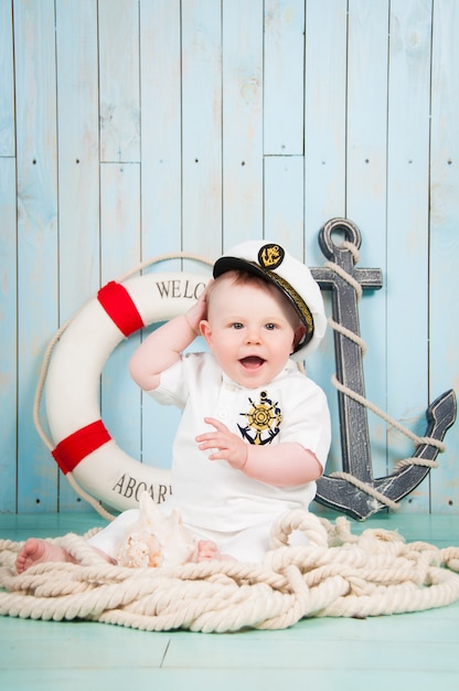 A small cheerful captain in a maritime interior