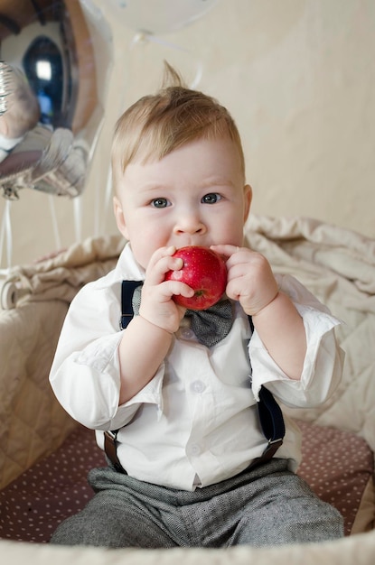 A small child eats an apple Closeup portrait