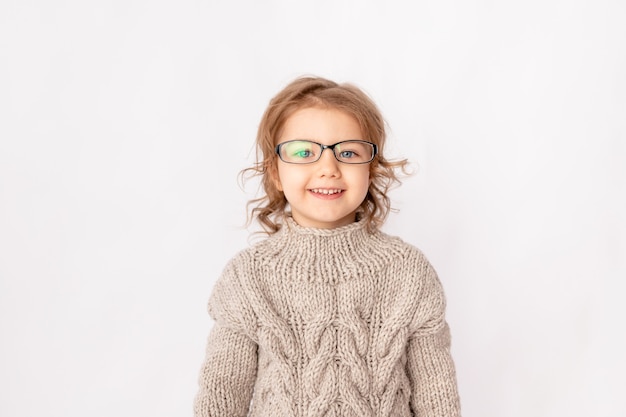 Small child girl with glasses on white background, space for text