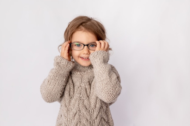 Small child girl with glasses on white background