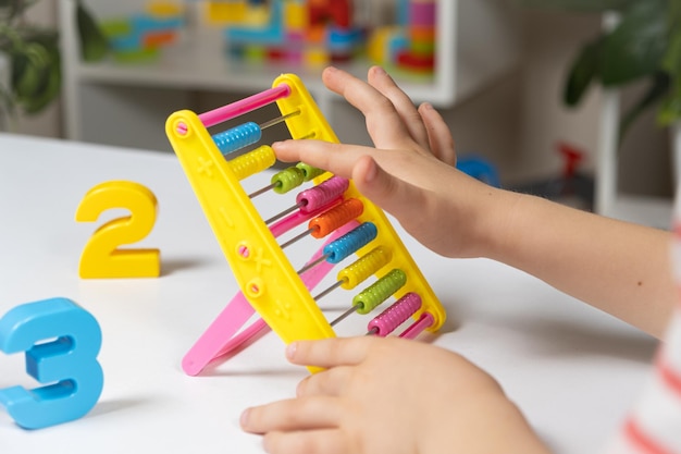 A small child learns to count on abacus mathematics arithmetic for children