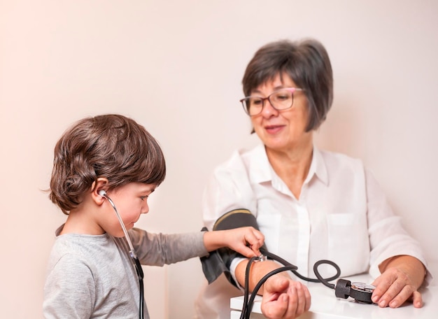 a small child measures the pressure of a grandmother