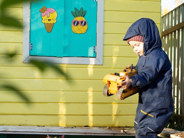 A small child plays in the sandbox on a sunny day