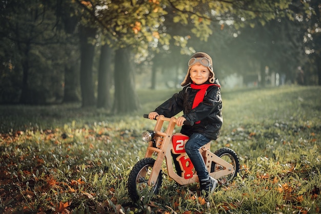 Small child sits on a balance bike in outerwear